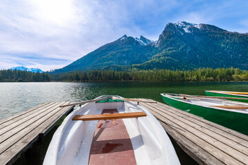 Boat dock with rowboats on Hintersee in Ramsau with a mountain idyll (Bavaria, Germany)