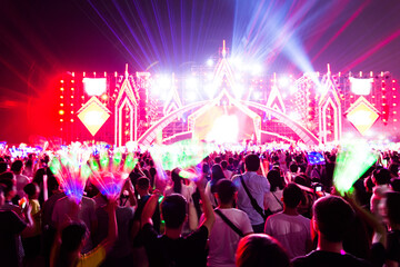 Cheering crowd in front of bright stage lights