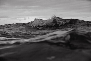 A black and white photo of a wave in the ocean