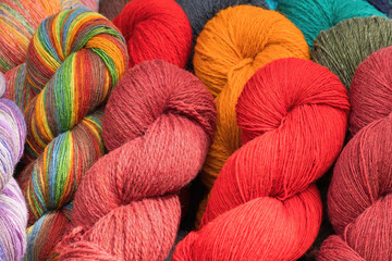 A lot of color yarn for knitting. Selection of colorful yarn wool on shopfront. Selective focus.