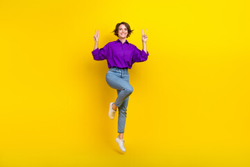 Fototapeta na wymiar Full body length photo of cheerful lady bob brown hair office manager jump showing v-sign start new job isolated on yellow color background