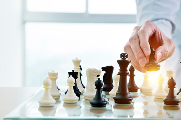Businessman playing chess on board in office