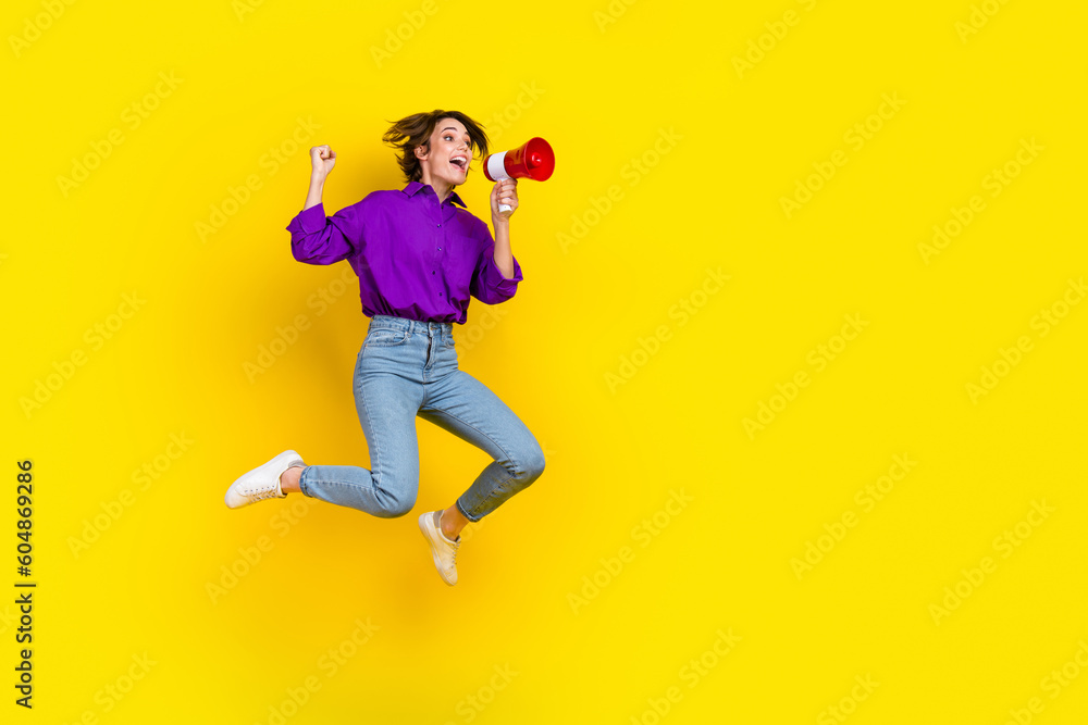 Poster full length photo of cool lucky lady wear violet shirt jumping shouting bullhorn empty space isolate