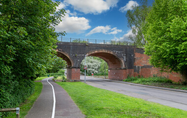 Fototapeta na wymiar Brick train bridge over a road in Witham city, Essex, England