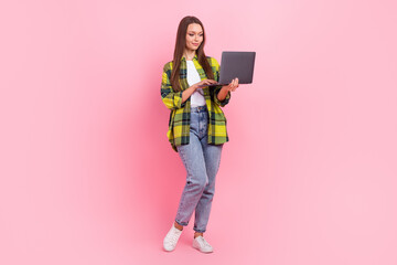 Full size photo of nice positive girl hold use wireless netbook isolated on pink color background