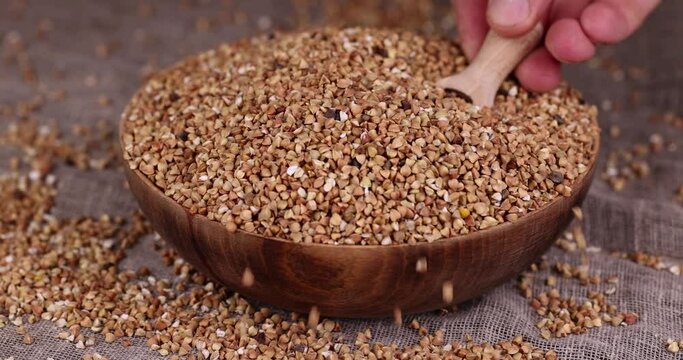 a large amount of low-quality processing of buckwheat groats close-up, Poorly cleaned buckwheat groats for cooking porridge