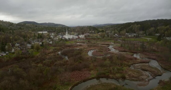 Drone 4K footage of Stowe Vermont flying over river toward Stowe Community Church on Main Street Vermont Rte 100