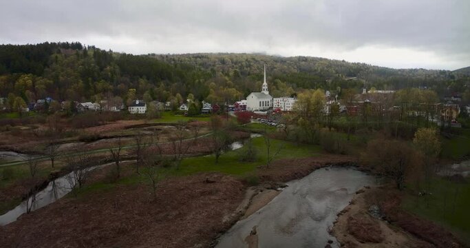 Drone 4K aerial footage over Stowe Vermont Rte 100 in early spring featuring Main Street and the famous church steeple