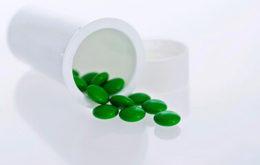 Pills and pill bottle isolated on white background