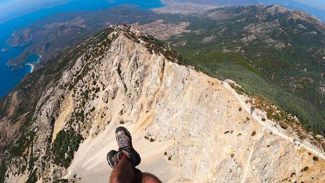 paragliding point of view flying over Oludeniz. legs paraglider over mountains and forests. Extreme and active types of recreation. panoramic view from the gopro. High quality FullHD footage