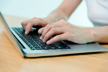 Woman hand typing on a laptop
