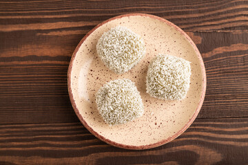 Japanese rice sweet buns mochi filled with pandan and coconut jam on brown wooden, top view