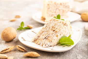 Walnut and almond cake on brown concrete, side view, selective focus.