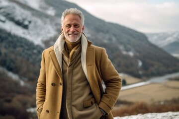 Lifestyle portrait photography of a glad mature man wearing a cozy winter coat against a picturesque countryside background. With generative AI technology