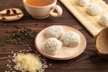 Japanese rice sweet buns mochi filled with pandan and coconut jam on brown wooden, side view