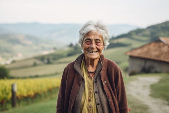 Environmental portrait photography of a grinning old woman wearing a chic cardigan against a picturesque countryside background. With generative AI technology