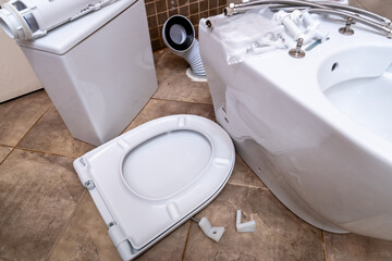 Installing a new toilet bowl in the restroom and its accessories, plumbing repair service,...