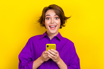 Portrait of surprised girl bob brown hair wear purple shirt hold phone unexpected salary day...