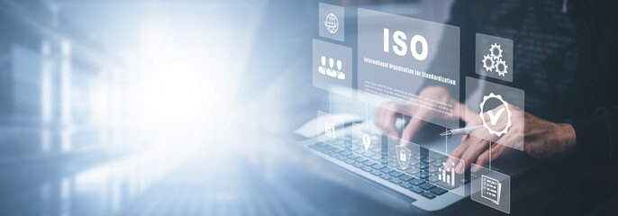 Hand hold Laptop with ISO standards quality control concept, assurance warranty in dark background, Cogs and gear wheel mechanisms, identification information security and encryption, secure access