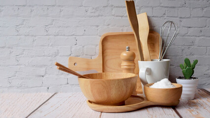 Kitchen accessories in white wooden table and white background and white tableware with salt in...