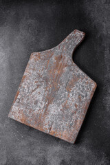 Empty wooden cutting board with cracks and scuffs
