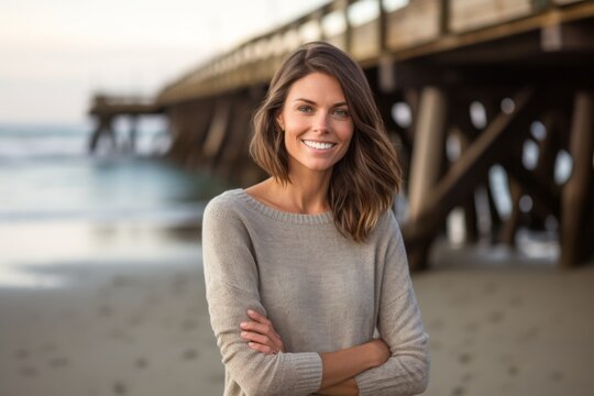 Medium shot portrait photography of a satisfied girl in her 30s wearing a cozy sweater against a scenic beach pier background. With generative AI technology