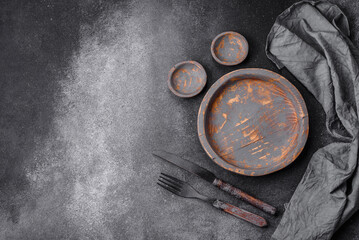 Empty wooden plate, knife, fork and cutting board