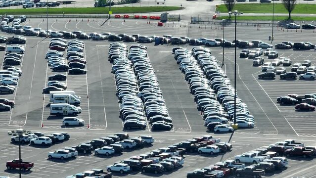 Long aerial shot of cars in auto auction parking lot. Selling, buying, leasing, trading cars theme.