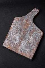 Empty wooden cutting board with cracks and scuffs