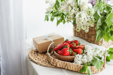 Strawberries on a tray and gift box, festive morning concept
