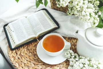 Open bible in spring interior, good morning concept