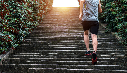 Low section of runner athlete running on staircase