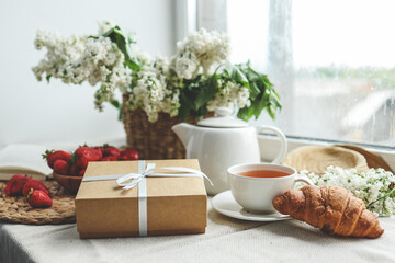 Gift box with a bow and holiday breakfast, surprise, good morning