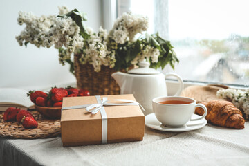 Gift box with a bow and holiday breakfast, surprise, good morning