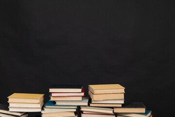 stack of books on a black background science learning library education