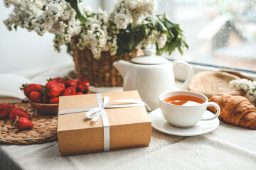 Gift box with a bow and holiday breakfast, surprise, good morning