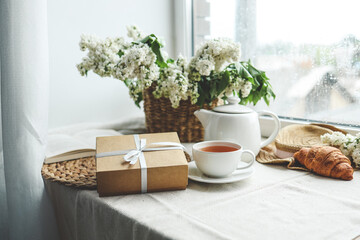 Gift box with a bow and holiday breakfast, surprise, good morning