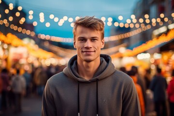 Fototapeta premium Lifestyle portrait photography of a satisfied mature boy wearing a stylish hoodie against a bustling outdoor bazaar background. With generative AI technology