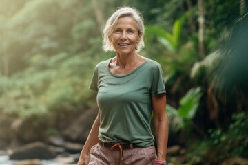 Environmental portrait photography of a satisfied mature woman wearing breezy shorts against a scenic tropical rainforest background. With generative AI technology