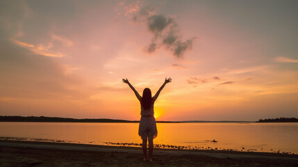 Happy woman silhouette in the sunset