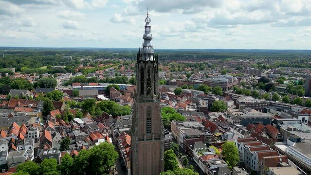 This aerial drone video shows the Lieve Vrouwentoren, a large clock tower in the old city center of Amersfoort. Amersfoort is a beautiful city in Utrecht, the Netherlands.