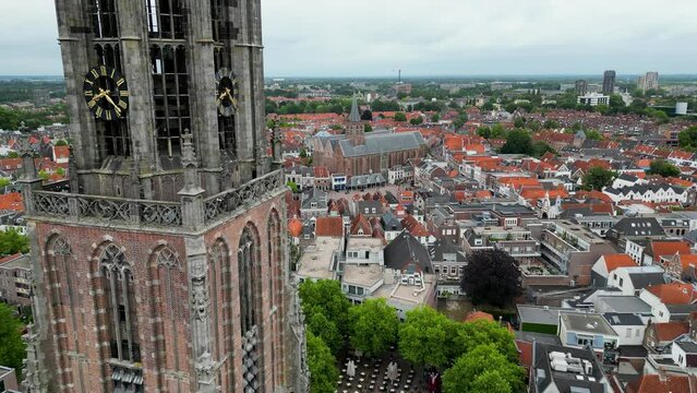 This aerial drone video shows the Lieve Vrouwentoren, a large clock tower in the old city center of Amersfoort. Amersfoort is a beautiful city in Utrecht, the Netherlands.