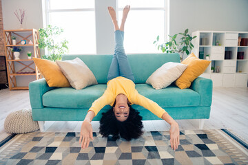 Full size portrait of crazy positive girl sit sofa upside down good mood chilling pastime apartment...