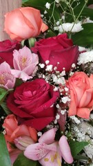 A bunch of white red and purple roses