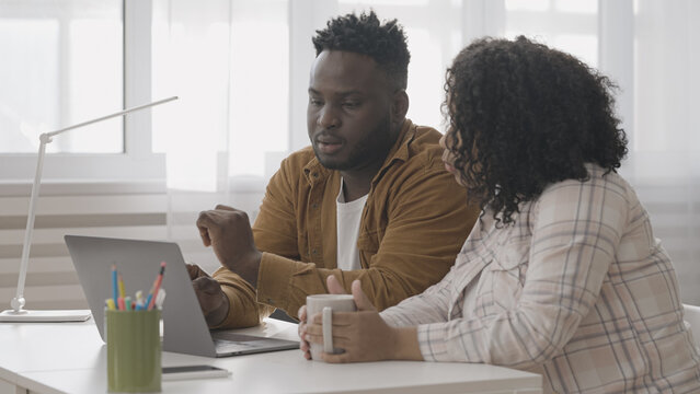 African American couple applying for mortgage loan on laptop to buy a new home
