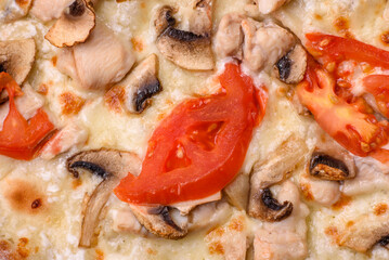 Delicious pizza with chicken, tomatoes and cheese with salt and sauce