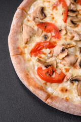 Delicious pizza with chicken, tomatoes and cheese with salt and sauce