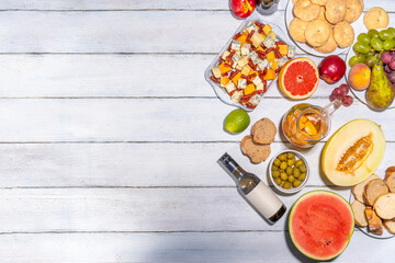 Buon Ferragosto (happy in italian language) holiday background. Summer Italian harvest festival August 15  brunch, family party antipasto foods with watermelon, melon, grapes, cheese, snacks, drinks © ricka_kinamoto
