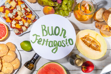 Buon Ferragosto (happy in italian language) holiday background. Summer Italian harvest festival August 15  brunch, family party antipasto foods with watermelon, melon, grapes, cheese, snacks, drinks