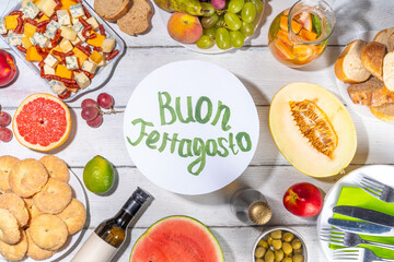Buon Ferragosto (happy in italian language) holiday background. Summer Italian harvest festival August 15  brunch, family party antipasto foods with watermelon, melon, grapes, cheese, snacks, drinks
